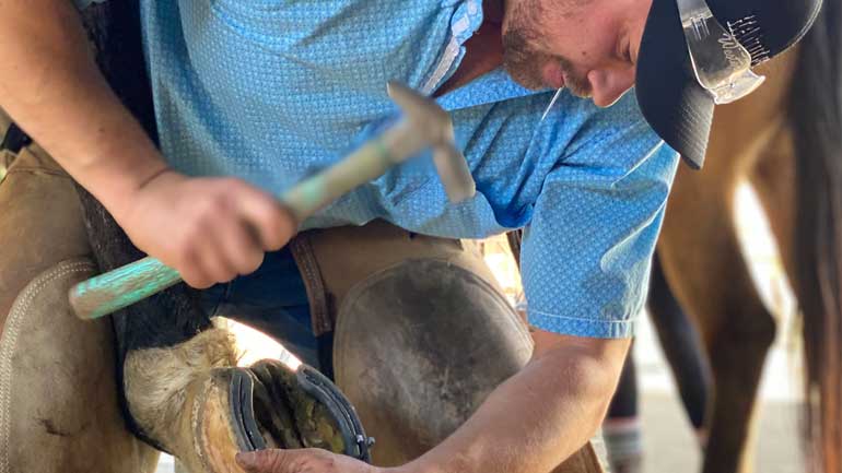 A student working hard to become a farrier